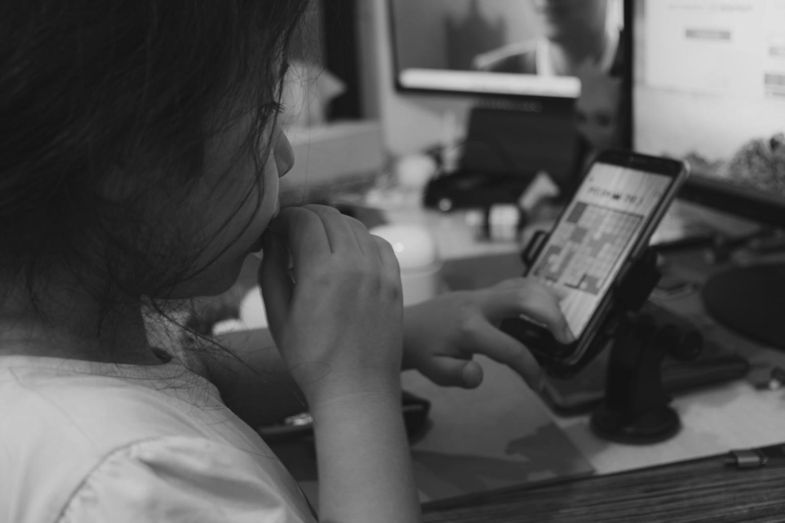 Financial analysis workspace with computer displaying budget spreadsheets and reports